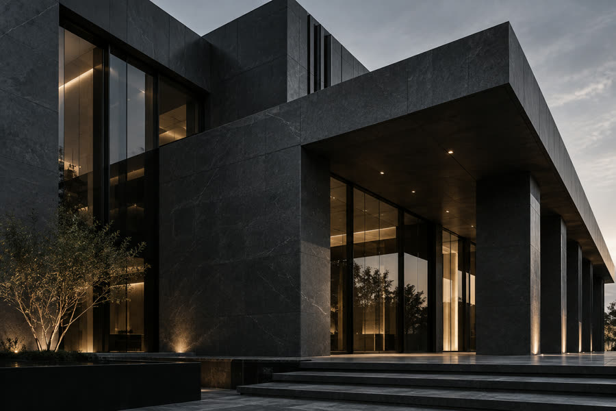 A modern dark stone building facade at dusk
